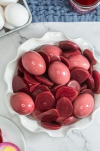 Red eggs served on a white plate.